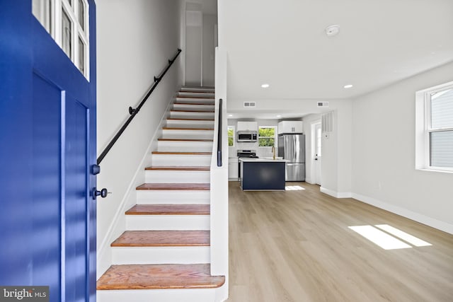 stairs featuring hardwood / wood-style flooring