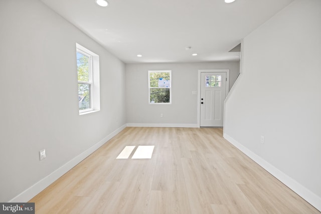 unfurnished room with light hardwood / wood-style floors and plenty of natural light