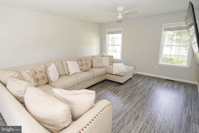 living room featuring plenty of natural light, ceiling fan, and dark hardwood / wood-style floors