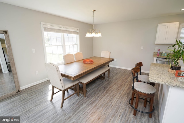 dining area featuring a notable chandelier and light hardwood / wood-style floors