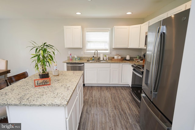 kitchen with stainless steel appliances, sink, and white cabinetry