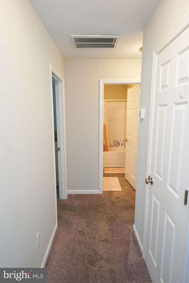 corridor with dark colored carpet