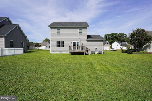 back of property with central AC unit, a lawn, and a wooden deck