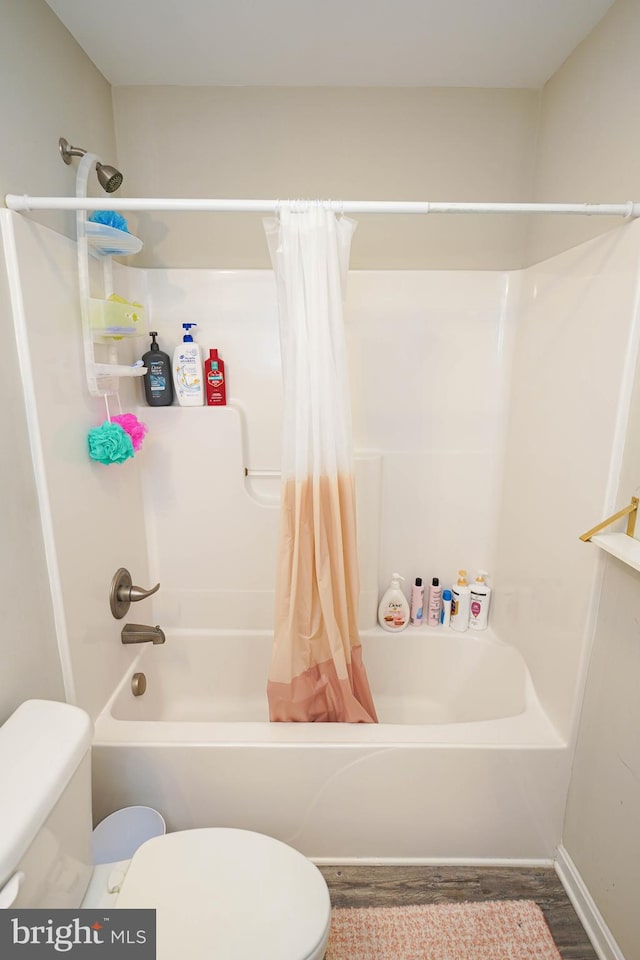 bathroom with toilet, wood-type flooring, and shower / bath combination with curtain