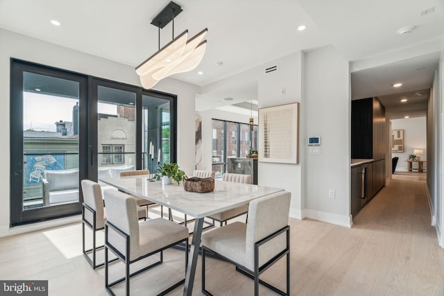 dining space featuring light hardwood / wood-style floors and a healthy amount of sunlight