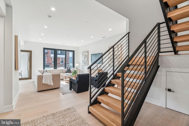 staircase with hardwood / wood-style flooring