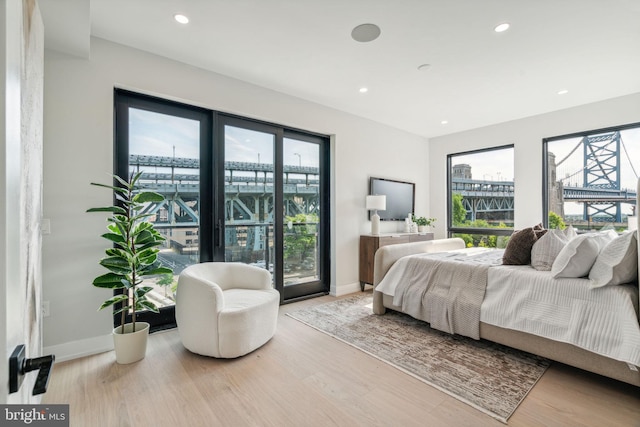 bedroom with wood-type flooring and multiple windows