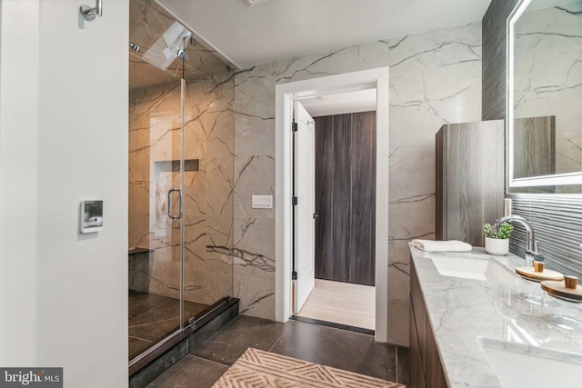 bathroom with tile walls, walk in shower, and vanity