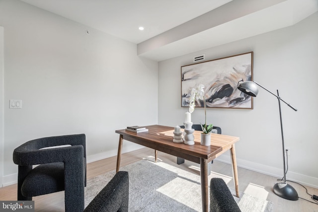 home office with light hardwood / wood-style flooring