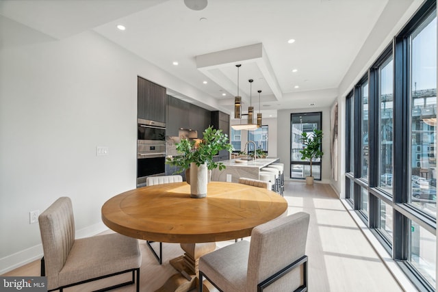 dining area featuring light hardwood / wood-style floors and sink