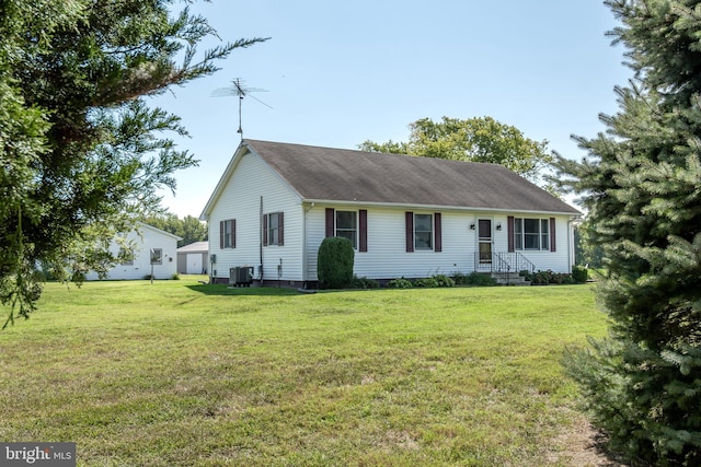 view of front of house with a front lawn and central AC