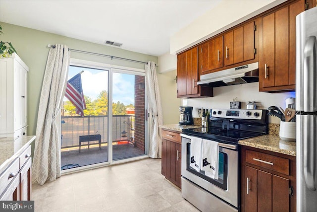 kitchen featuring light stone countertops and stainless steel appliances