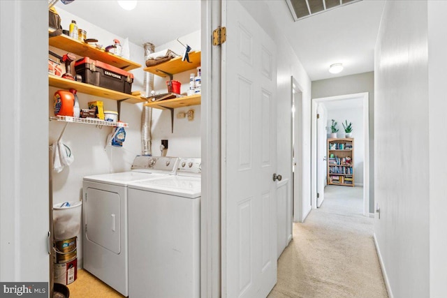 laundry area with light colored carpet and washing machine and clothes dryer