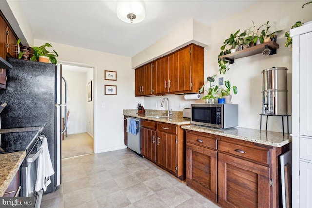 kitchen featuring light stone counters, sink, stainless steel appliances, and exhaust hood