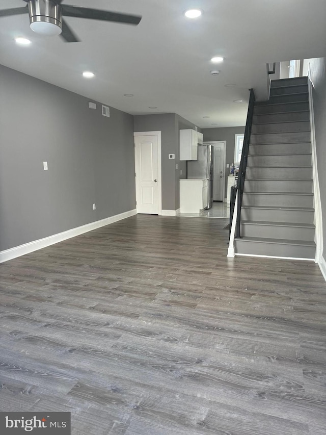 interior space featuring ceiling fan, hardwood / wood-style floors, and stainless steel refrigerator