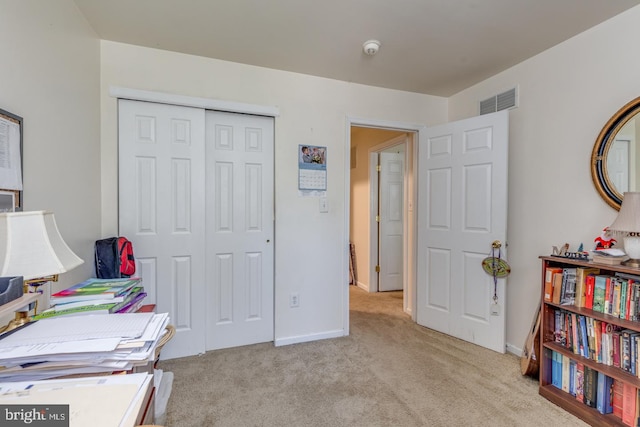 office area featuring light carpet