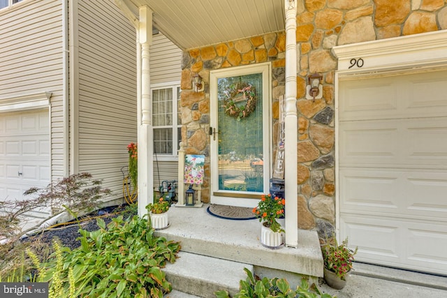 property entrance with a garage and a porch