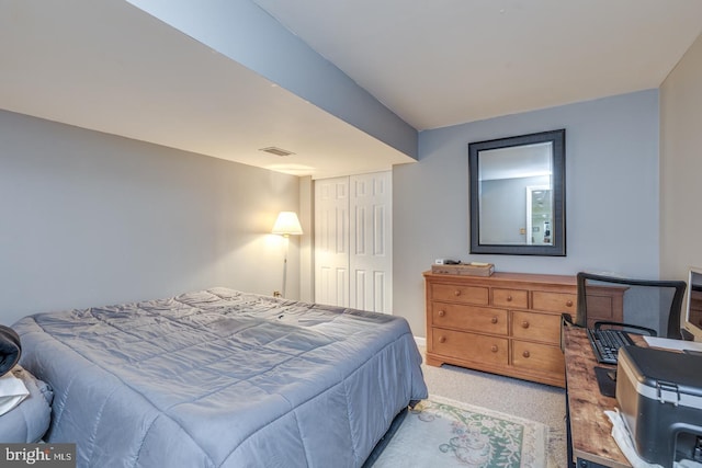 bedroom with a closet and light carpet