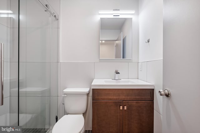 bathroom featuring vanity, toilet, an enclosed shower, and backsplash