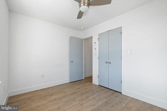 unfurnished bedroom featuring a closet, ceiling fan, and light hardwood / wood-style flooring