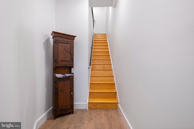 stairs with hardwood / wood-style floors