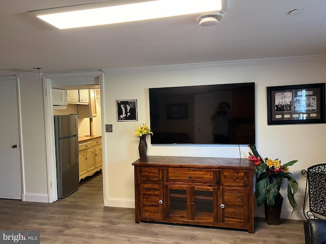 interior space featuring hardwood / wood-style flooring and ornamental molding