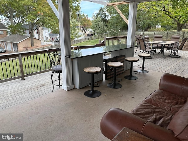 wooden terrace featuring a bar