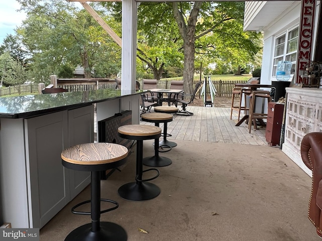 wooden terrace featuring a bar