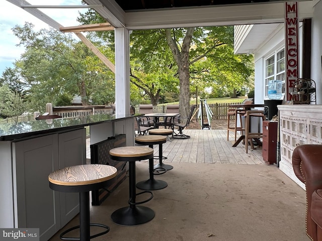 wooden terrace featuring a bar