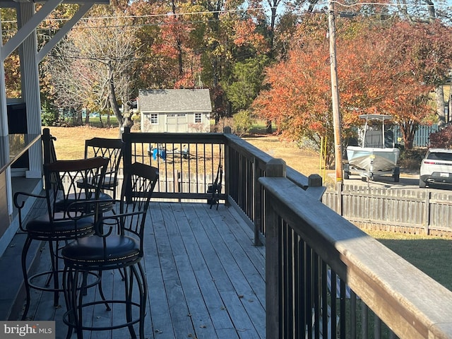 wooden terrace featuring an outdoor structure