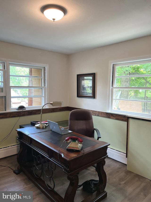 office area featuring wood-type flooring and a baseboard heating unit