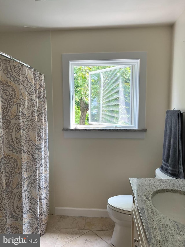 bathroom with tile patterned floors, vanity, and toilet