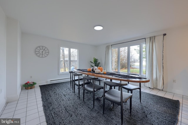 dining space with light tile patterned floors, a baseboard radiator, and a healthy amount of sunlight