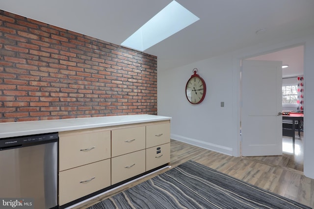 unfurnished bedroom featuring light hardwood / wood-style floors and brick wall