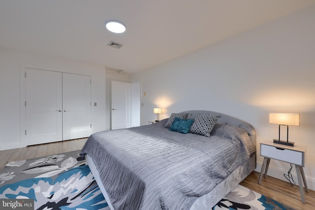 bedroom featuring hardwood / wood-style floors and a closet