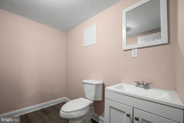 bathroom with vanity, hardwood / wood-style floors, and toilet