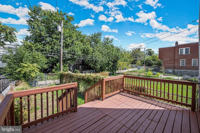 wooden deck with a lawn