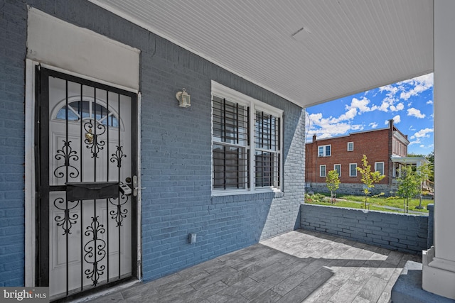 doorway to property featuring covered porch