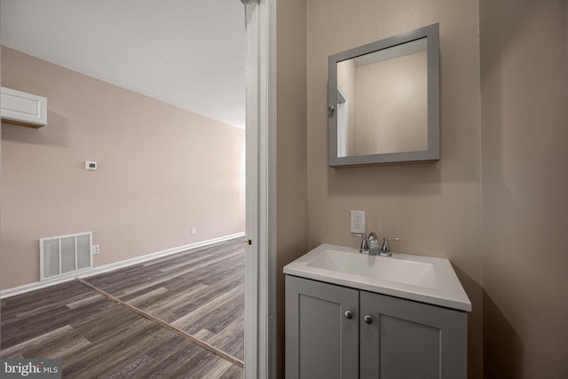 bathroom with hardwood / wood-style floors and vanity