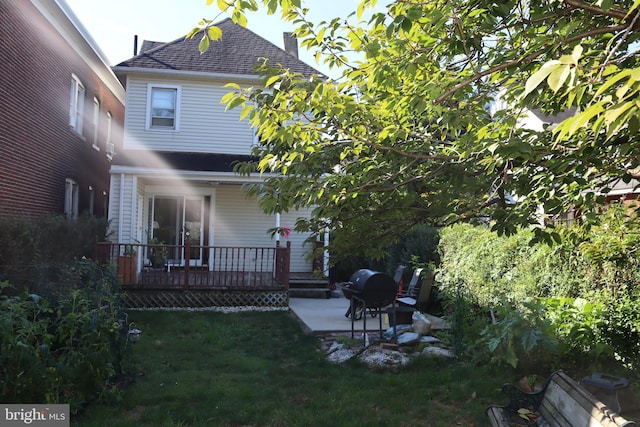 rear view of property with a patio area and a lawn