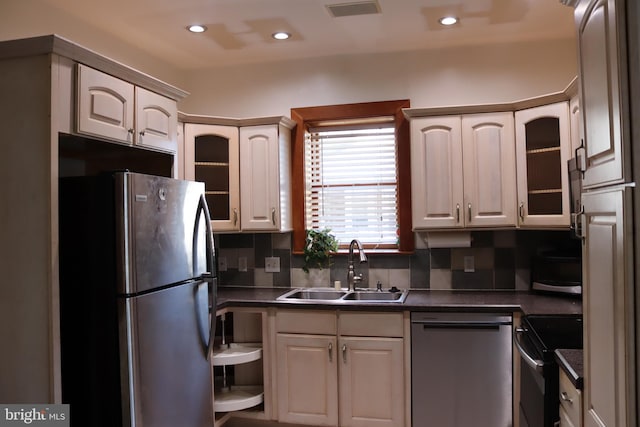 kitchen featuring stainless steel appliances, tasteful backsplash, and sink