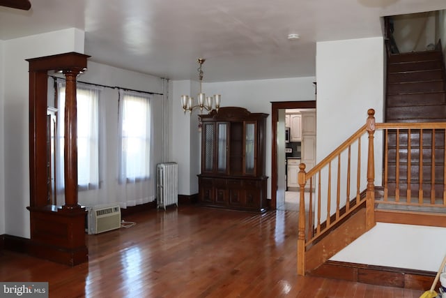 entrance foyer with a chandelier, dark hardwood / wood-style floors, and radiator heating unit