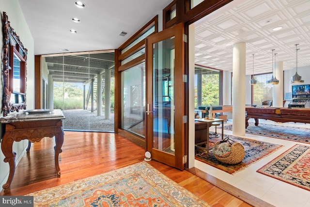 interior space featuring floor to ceiling windows, light wood-type flooring, and plenty of natural light