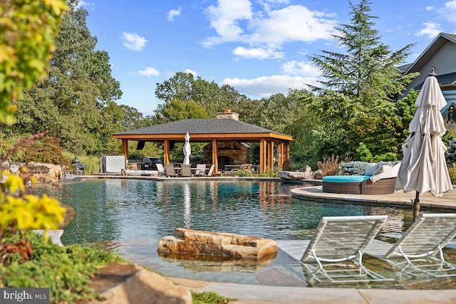 view of pool with outdoor lounge area, a gazebo, and a patio