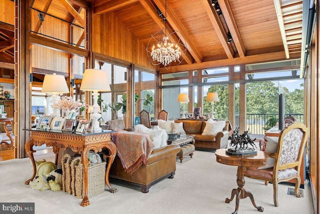 living room featuring carpet flooring, beam ceiling, a chandelier, and high vaulted ceiling