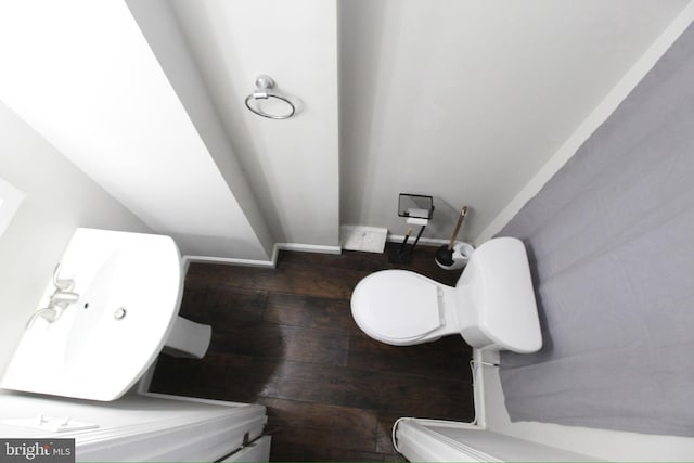 bathroom with wood-type flooring and toilet