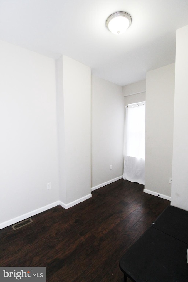 empty room featuring dark hardwood / wood-style floors