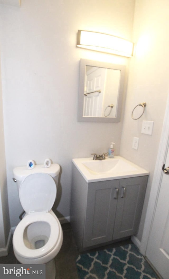 bathroom featuring vanity and toilet