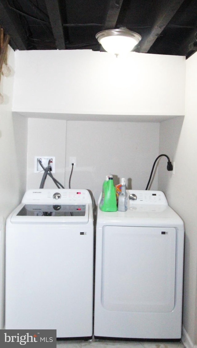 clothes washing area with washer and dryer