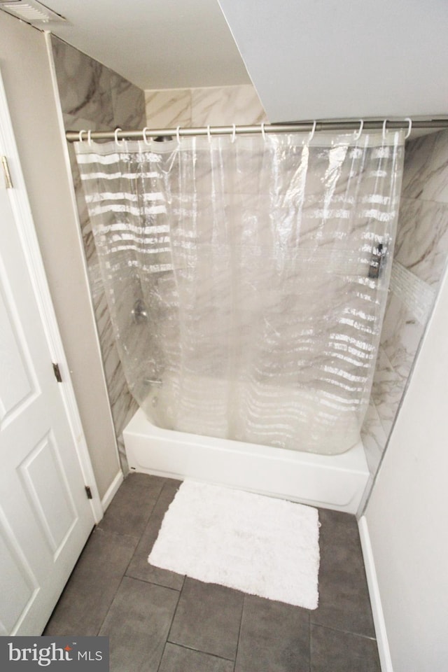 bathroom featuring tile patterned flooring and shower / tub combo